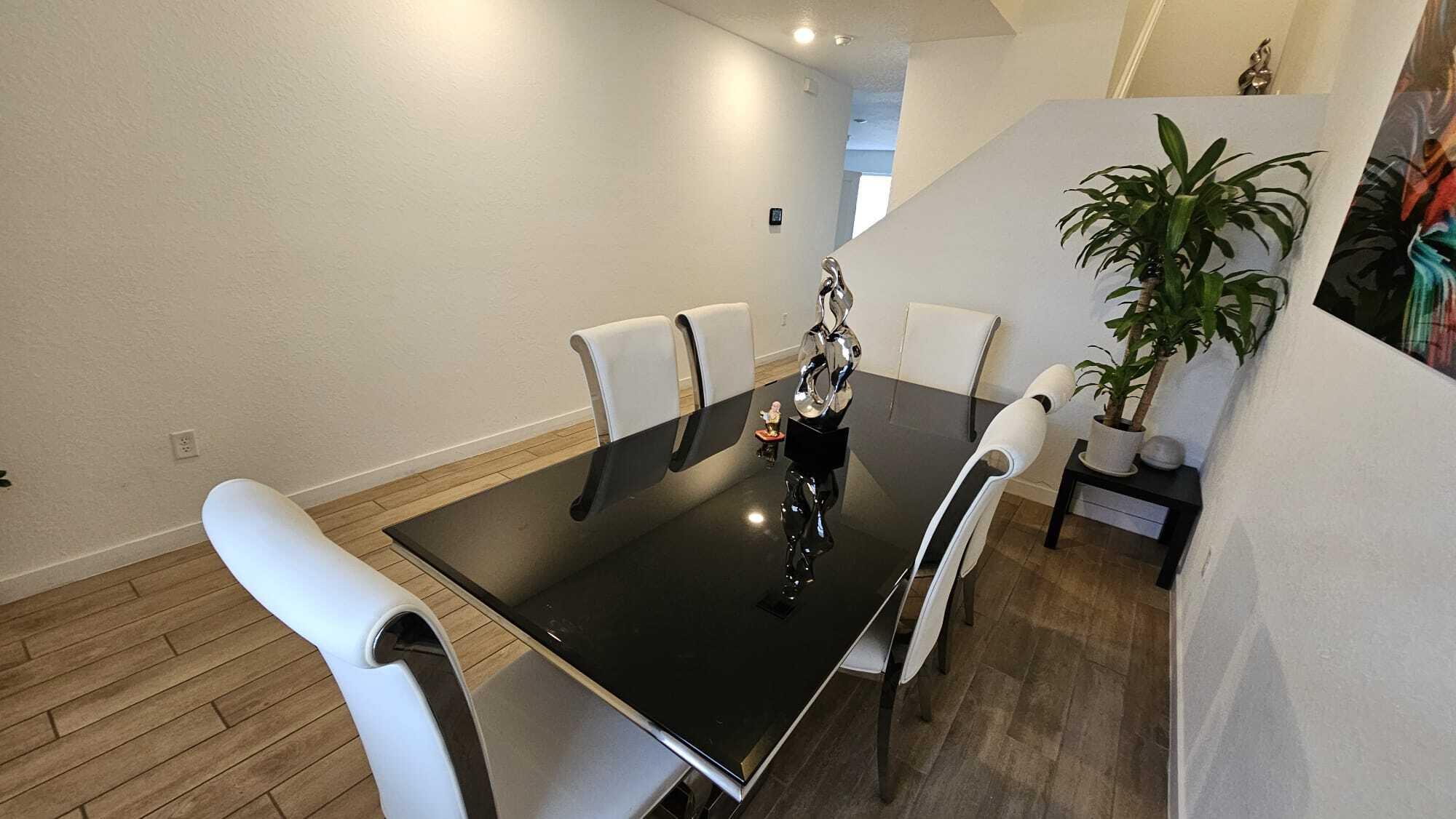1677 Southeast 8th Street Homestead, FL 33034 - Photo 18 of 52 a view of a dining room with furniture and wooden floor