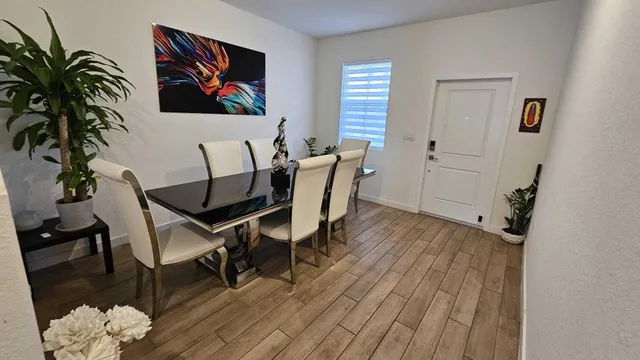 a view of a workspace with furniture and wooden floor