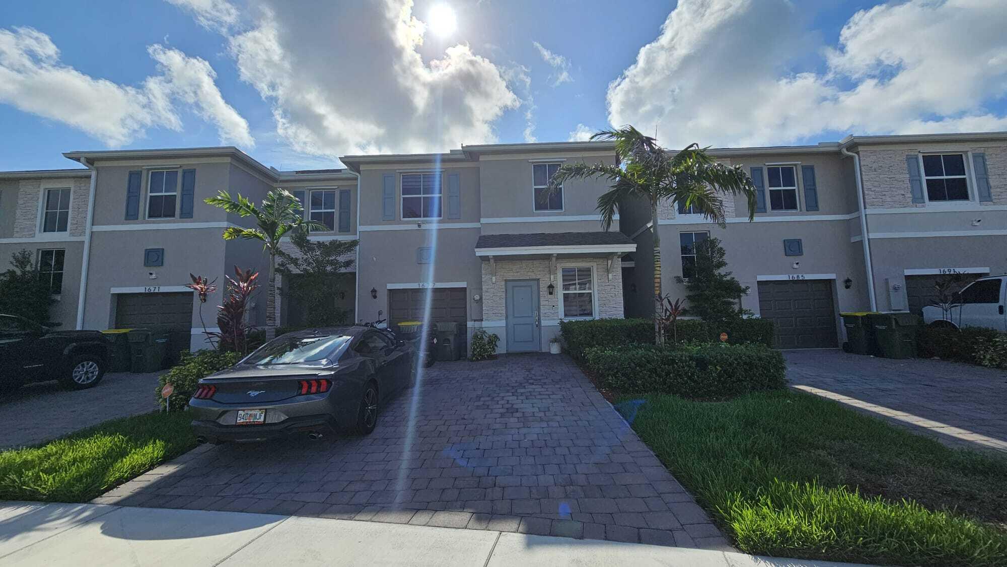 1677 Southeast 8th Street Homestead, FL 33034 - Photo 2 of 52 a front view of a house with a garden
