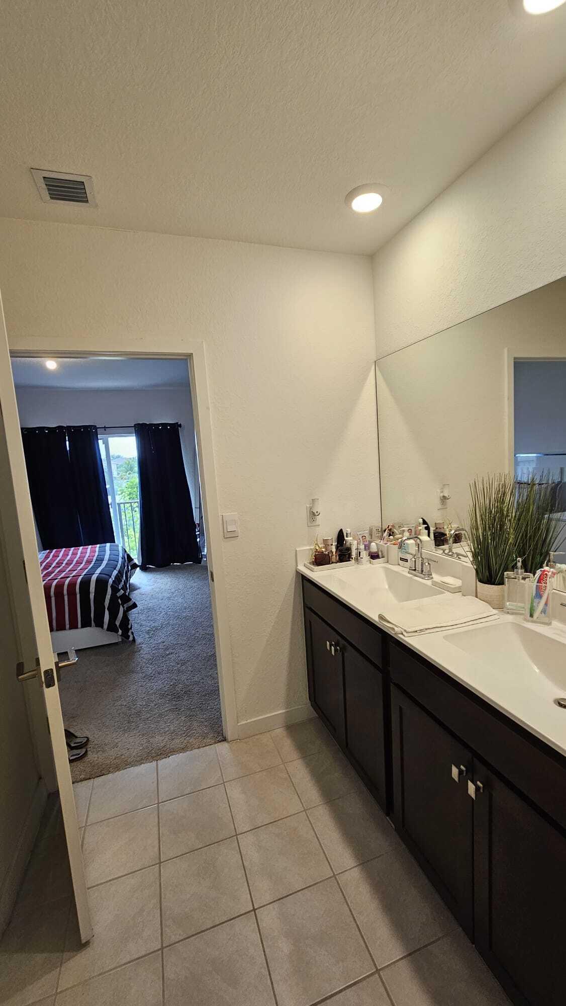 1677 Southeast 8th Street Homestead, FL 33034 - Photo 27 of 52 a spacious bathroom with a double vanity sink and a mirror