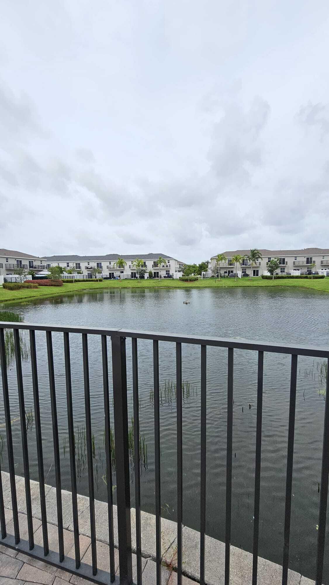 1677 Southeast 8th Street Homestead, FL 33034 - Photo 28 of 52 a balcony with wooden floor and city view