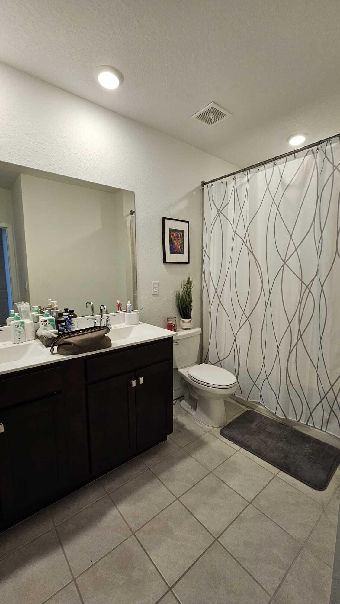1677 Southeast 8th Street Homestead, FL 33034 - Photo 30 of 52 a spacious bathroom with a double vanity sink toilet and a mirror
