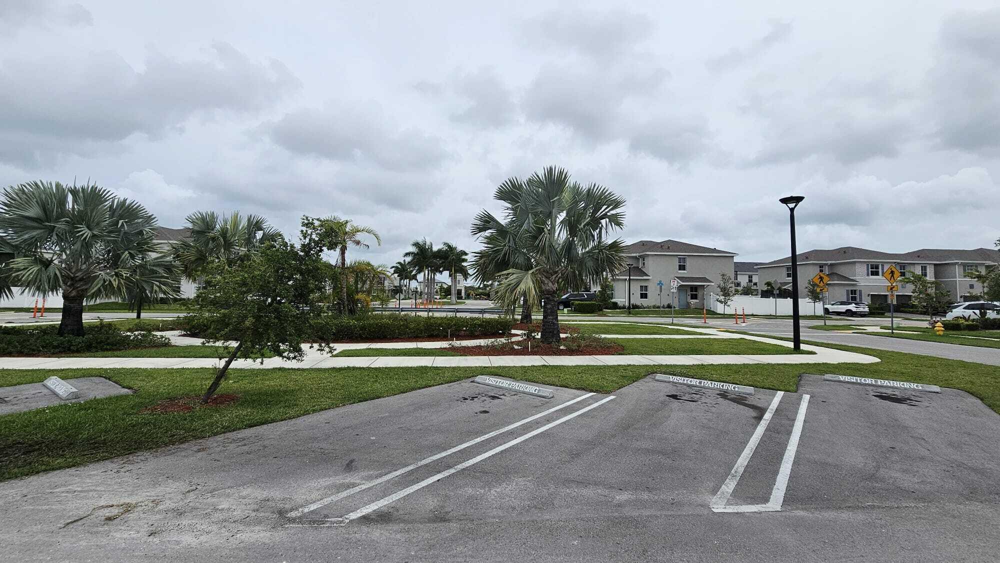1677 Southeast 8th Street Homestead, FL 33034 - Photo 37 of 52 a view of street with houses and trees in the background