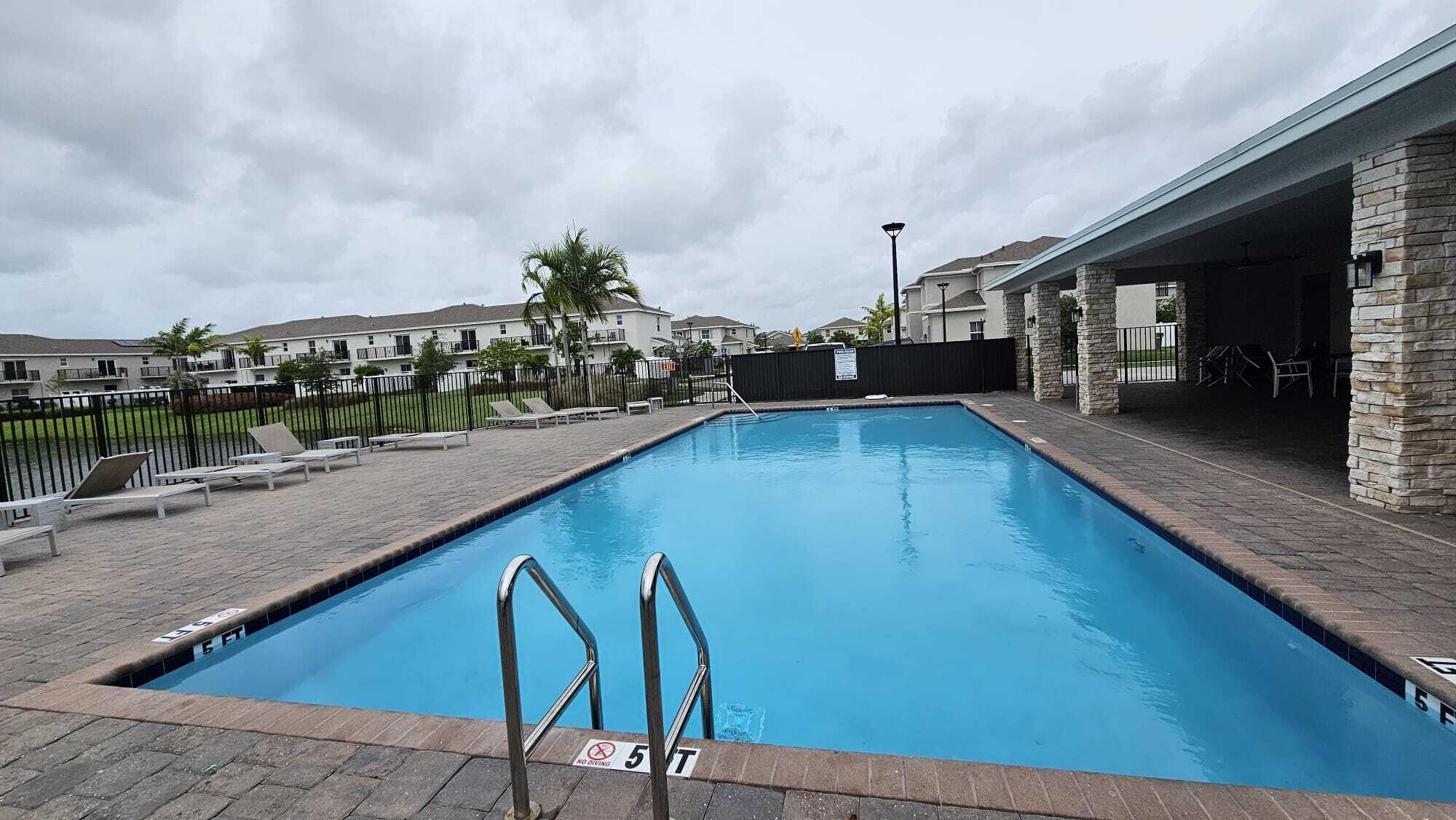 1677 Southeast 8th Street Homestead, FL 33034 - Photo 45 of 52 a view of a swimming pool with a lounge chair