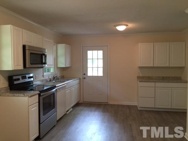 536 Gay Road Zebulon, NC 27597 - Photo 3 of 4 a kitchen with a sink stove and microwave
