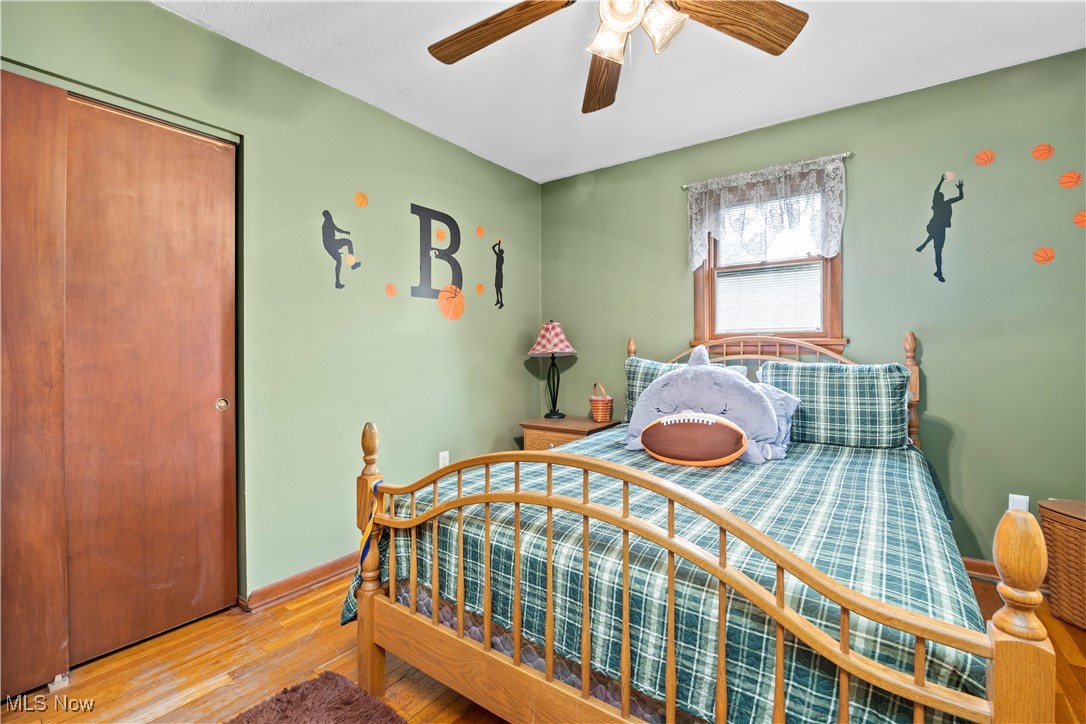 11811 Robson Road Grafton, OH 44044 - Photo 29 of 50 Bedroom with wood finished floors, a closet, baseboards, and ceiling fan