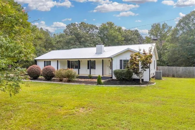 a front view of a house with swimming pool having outdoor seating