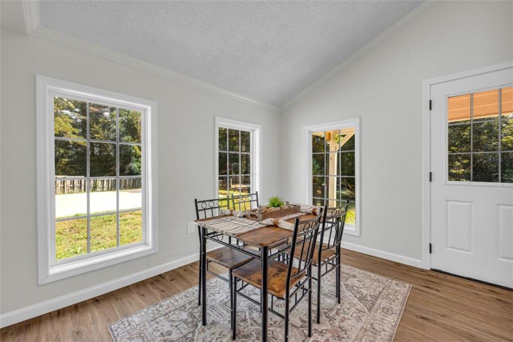 9597 Highway 334 Nicholson, GA 30565 - Photo 12 of 41 a view of a dining room with furniture and wooden floor