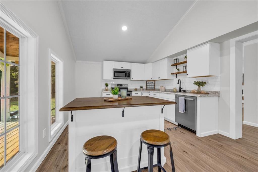 9597 Highway 334 Nicholson, GA 30565 - Photo 15 of 41 a kitchen with stainless steel appliances granite countertop a sink and a refrigerator