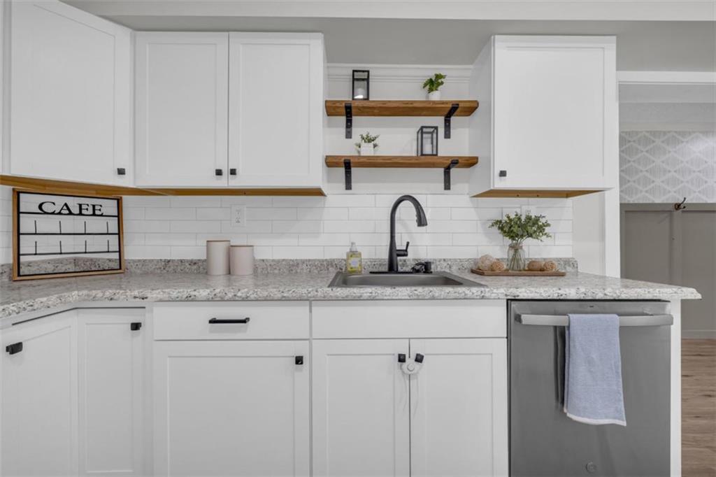9597 Highway 334 Nicholson, GA 30565 - Photo 18 of 41 a kitchen with granite countertop a sink stainless steel appliances and cabinets