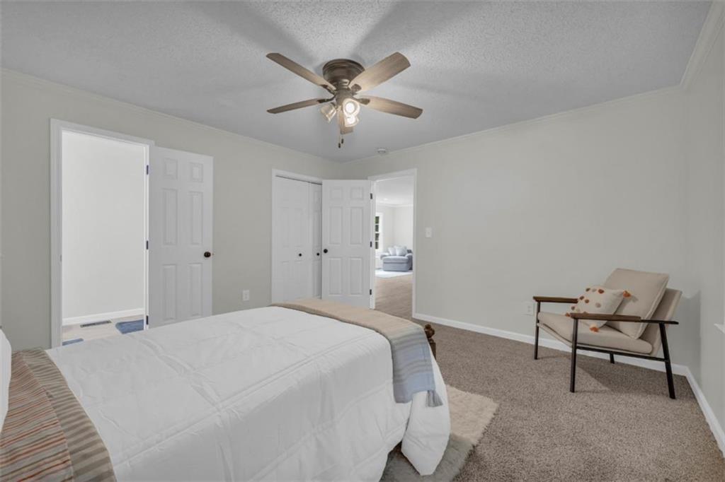 9597 Highway 334 Nicholson, GA 30565 - Photo 27 of 41 a bedroom with a bed and a chandelier
