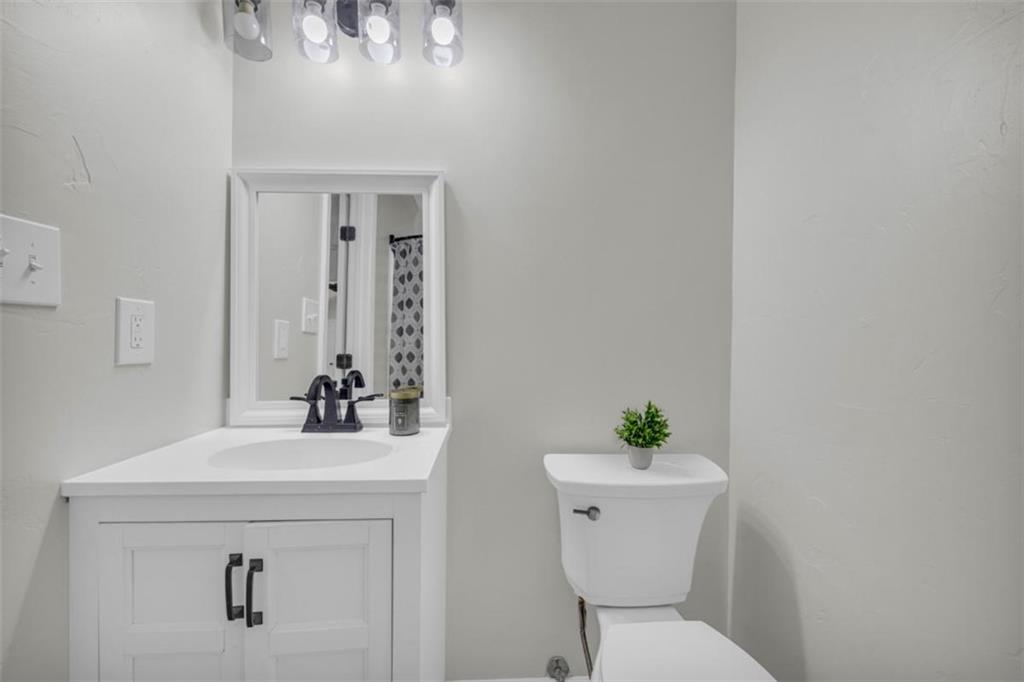 9597 Highway 334 Nicholson, GA 30565 - Photo 28 of 41 a bathroom with a sink a toilet and a mirror