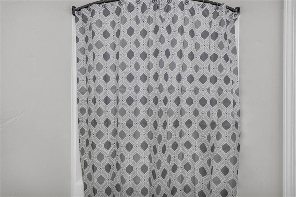 9597 Highway 334 Nicholson, GA 30565 - Photo 29 of 41 a bathroom with a black and white checkered curtain