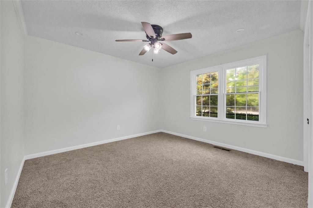 9597 Highway 334 Nicholson, GA 30565 - Photo 35 of 41 an empty room with windows and fan