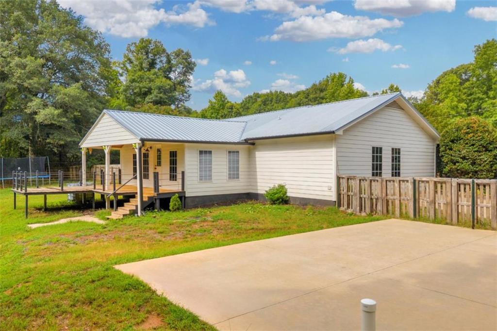9597 Highway 334 Nicholson, GA 30565 - Photo 39 of 41 a view of a house with a patio and a yard