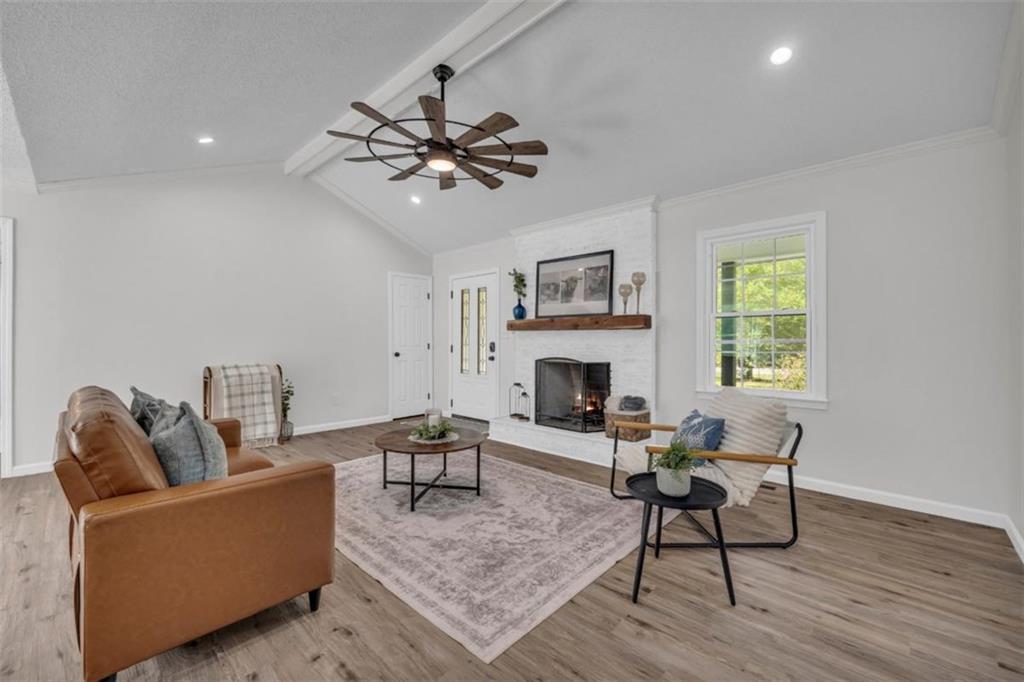 9597 Highway 334 Nicholson, GA 30565 - Photo 5 of 41 a living room with furniture and a fireplace