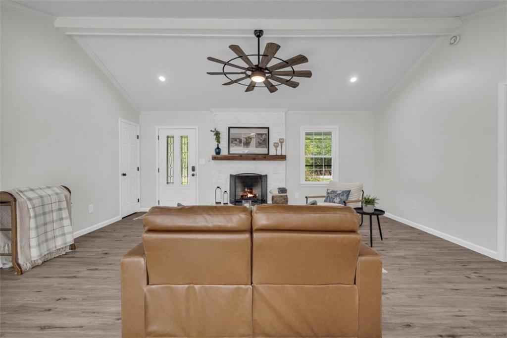 9597 Highway 334 Nicholson, GA 30565 - Photo 7 of 41 a living room with furniture a fireplace and a window