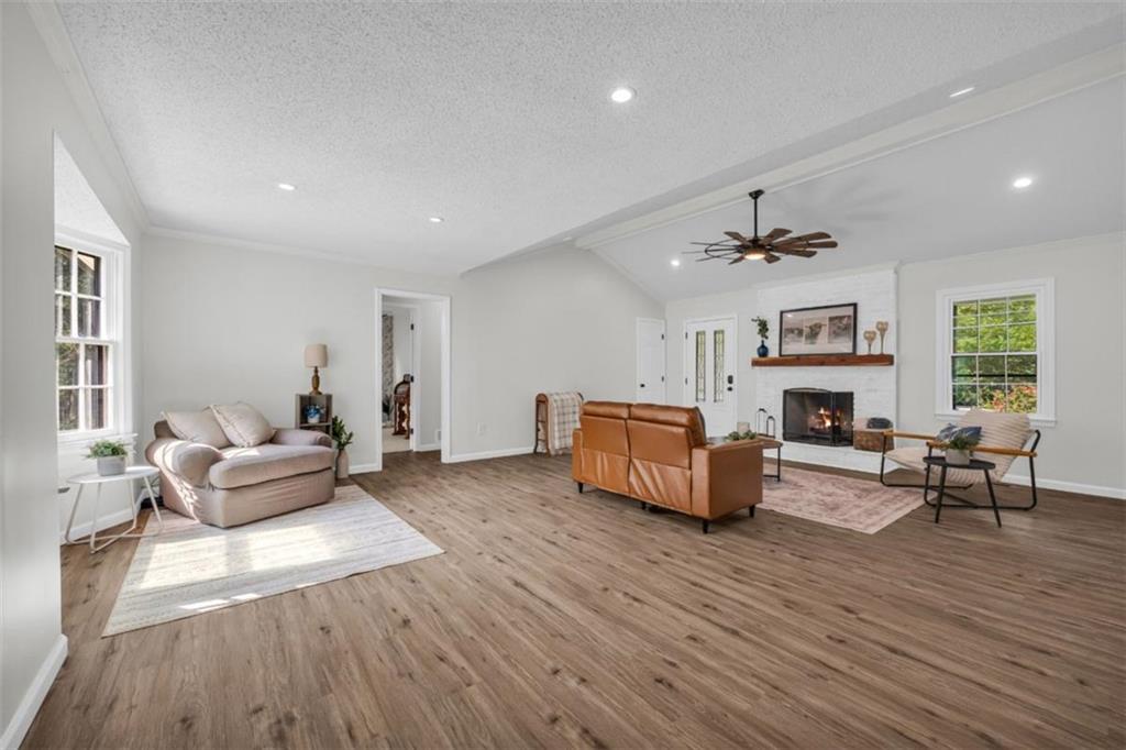 9597 Highway 334 Nicholson, GA 30565 - Photo 8 of 41 a living room with furniture wooden floor and a fireplace