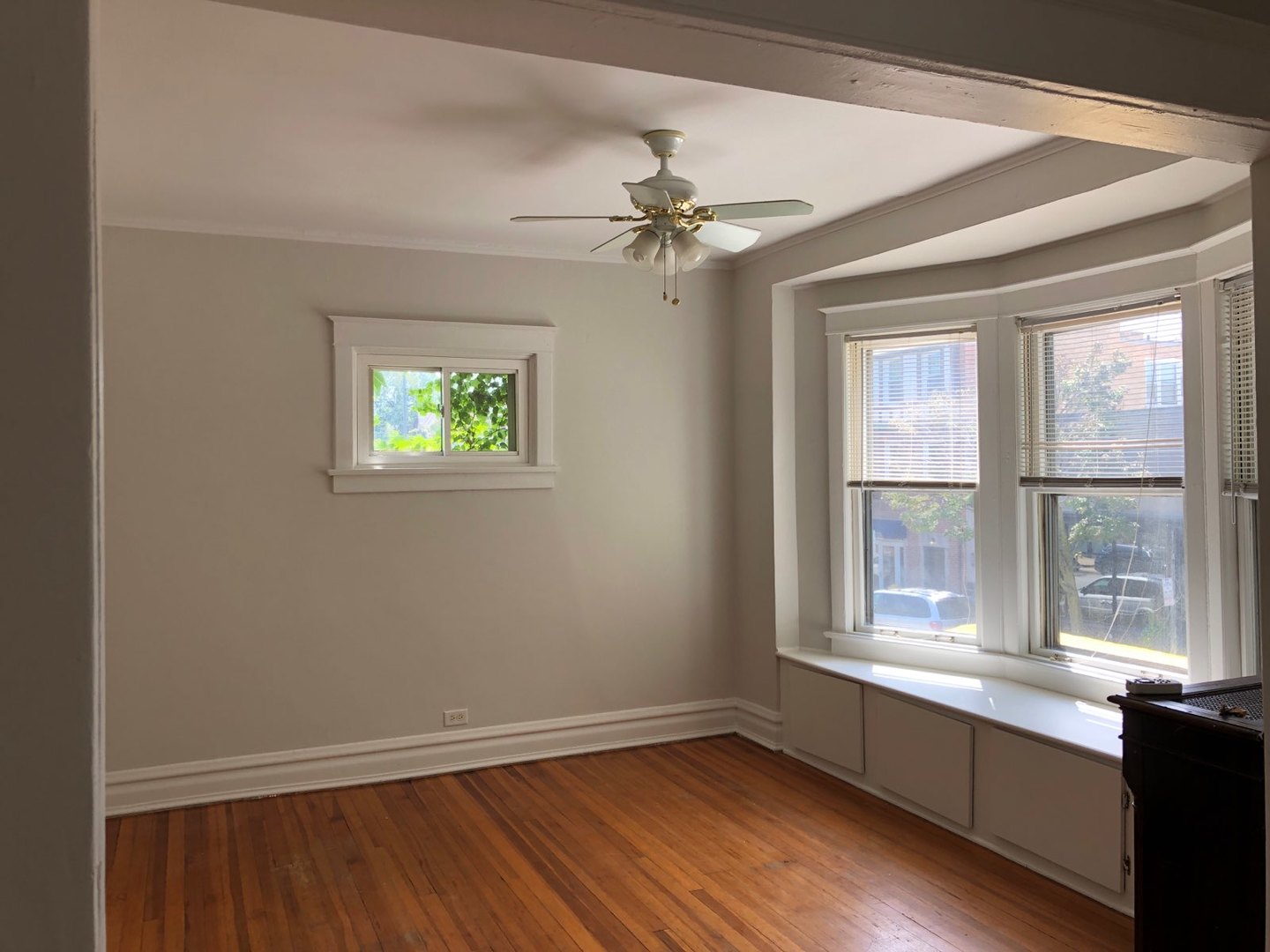 933 Green Bay Road Winnetka, IL 60093 - Photo 19 of 46 an empty room with wooden floor a ceiling fan and windows
