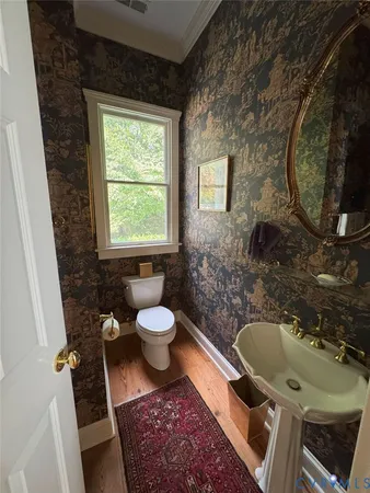 a bathroom with a toilet sink and mirror