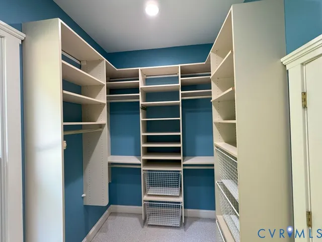 a view of walk in closet with empty racks