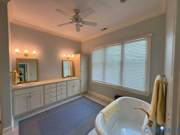 a large bathroom with a large tub and sink