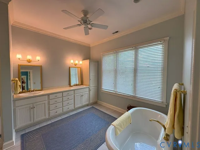 a large bathroom with a large tub and sink