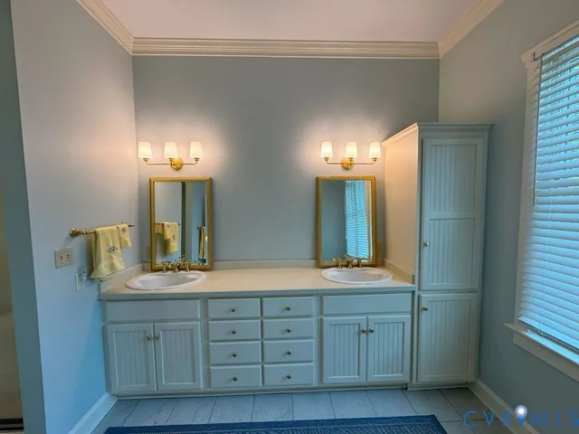 a bathroom with a double vanity sink and a mirror
