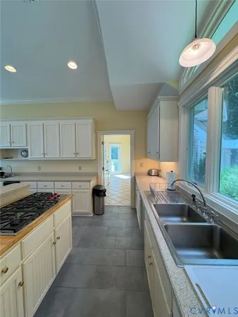 a kitchen that has a sink and a stove