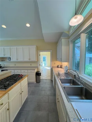 a kitchen that has a sink and a stove