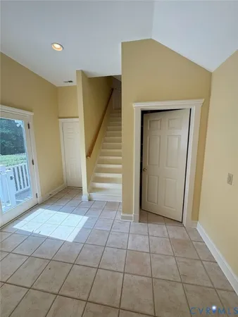 a view of a hallway with entryway door