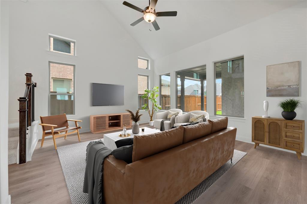 1908 Cola Drive Van Alstyne, TX 75495 - Photo 21 of 29 Living area featuring high vaulted ceilings with a ceiling fan, wood-finish flooring, and multiple large windows