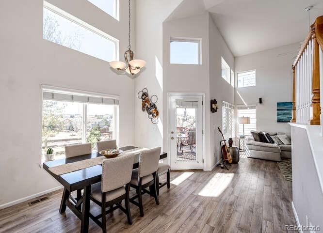 10143 Astorbrook Lane Highlands Ranch, CO 80126 - Photo 11 of 39 a view of a dining room with furniture window and wooden floor