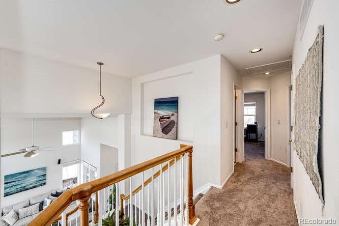 10143 Astorbrook Lane Highlands Ranch, CO 80126 - Photo 14 of 39 a view of a hallway view with staircase