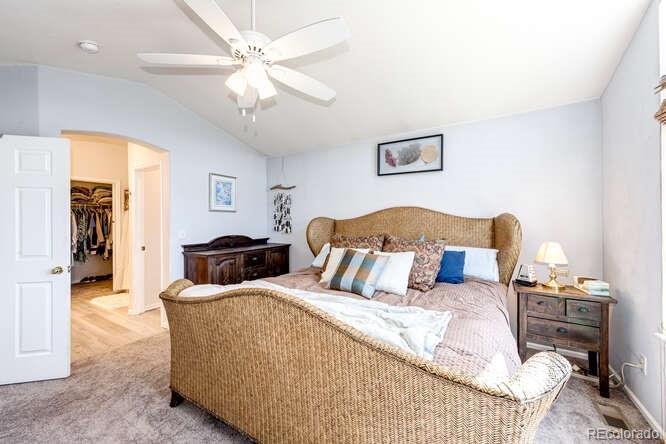 10143 Astorbrook Lane Highlands Ranch, CO 80126 - Photo 17 of 39 a bedroom with a bed and a chandelier