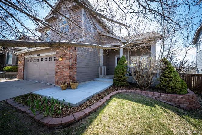 10143 Astorbrook Lane Highlands Ranch, CO 80126 - Photo 2 of 39 a view of a backyard with plants