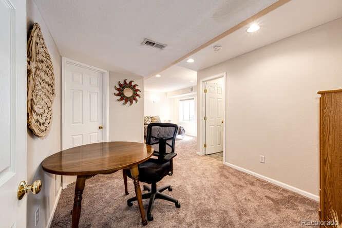10143 Astorbrook Lane Highlands Ranch, CO 80126 - Photo 25 of 39 a view of a workspace room with furniture and wooden floor