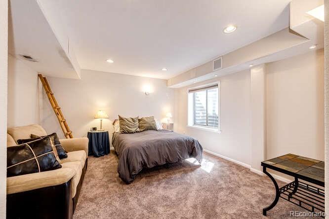 10143 Astorbrook Lane Highlands Ranch, CO 80126 - Photo 26 of 39 a bedroom with a bed and wooden floor
