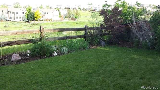 10143 Astorbrook Lane Highlands Ranch, CO 80126 - Photo 35 of 39 a view of a garden with an outdoor space and seating area