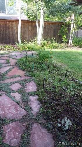 10143 Astorbrook Lane Highlands Ranch, CO 80126 - Photo 38 of 39 a view of garden with plants and wooden fence