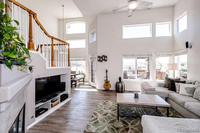 10143 Astorbrook Lane Highlands Ranch, CO 80126 - Photo 4 of 39 a living room with furniture wooden floor and a flat screen tv