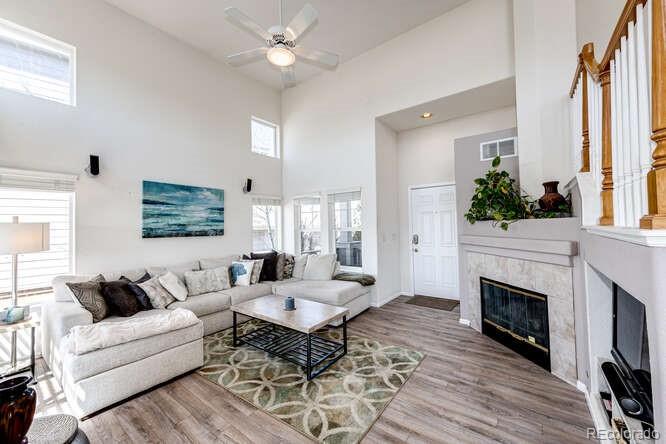 10143 Astorbrook Lane Highlands Ranch, CO 80126 - Photo 5 of 39 a living room with furniture a fireplace and a large window