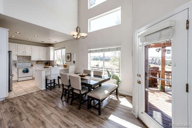 10143 Astorbrook Lane Highlands Ranch, CO 80126 - Photo 7 of 39 a view of a dining room with furniture window and wooden floor
