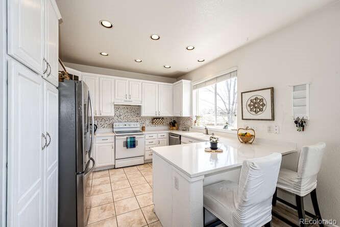10143 Astorbrook Lane Highlands Ranch, CO 80126 - Photo 8 of 39 a kitchen with a sink cabinets and window