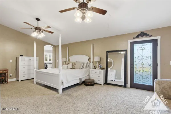 a bedroom with a bed and a chandelier