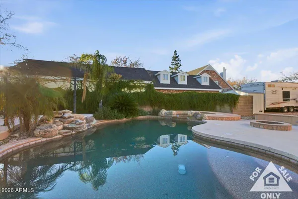 a swimming pool with outdoor seating and yard