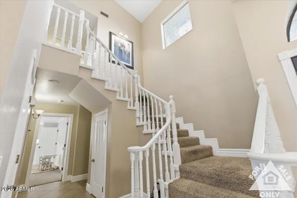 a kitchen with kitchen island granite countertop a sink a stove a refrigerator cabinets and dining table