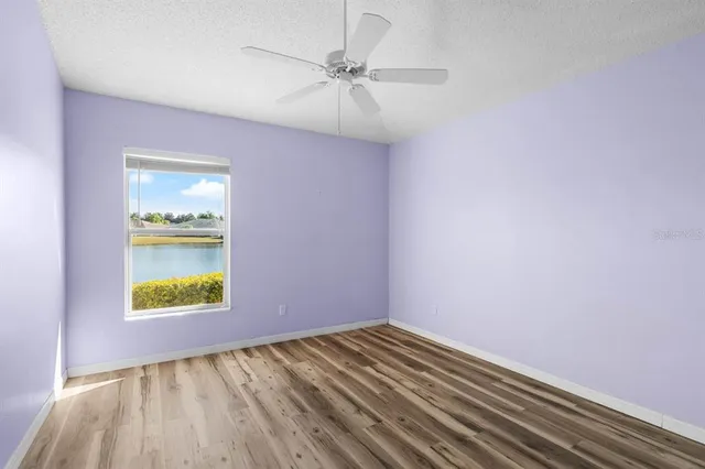 a bathroom with a granite countertop toilet a sink and mirror