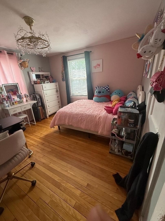 66 Powell Avenue Springfield, MA 01118 - Photo 13 of 31 a bedroom with a bed and a chandelier