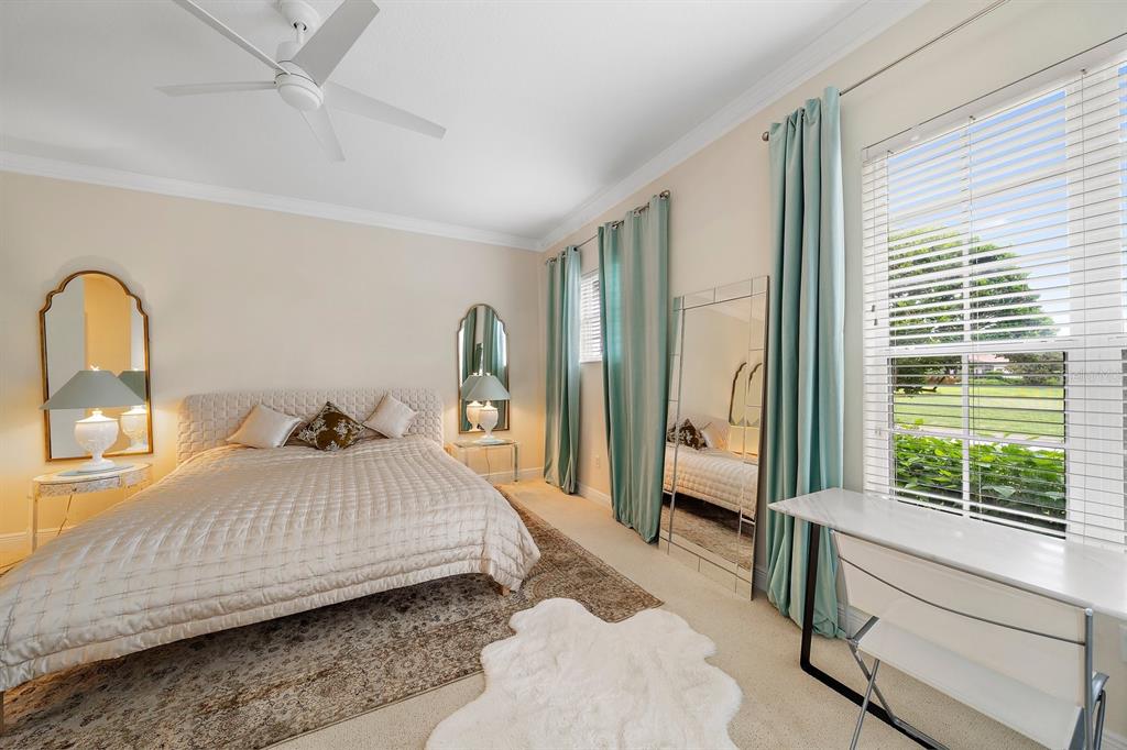 8406 Miramar Way, Unit 8406 Lakewood Ranch, FL 34202 - Photo 11 of 31 a bedroom with a large bed and a large window